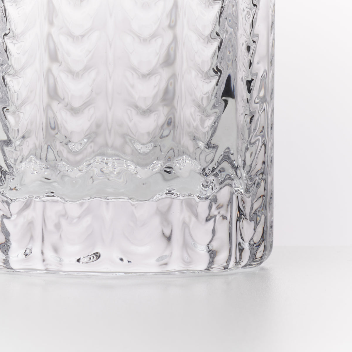 Clear glass Collins glasses with textured quilted pattern on exterior surface.