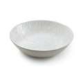 White ceramic serving bowl with radiating line pattern throughout interior and exterior.