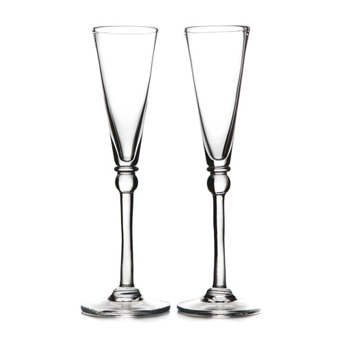 Two clear glass champagne flutes with tapered bowls and decorative stem bases.