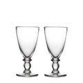 Two clear glass water glasses with decorative pedestal bases and wide bowls.