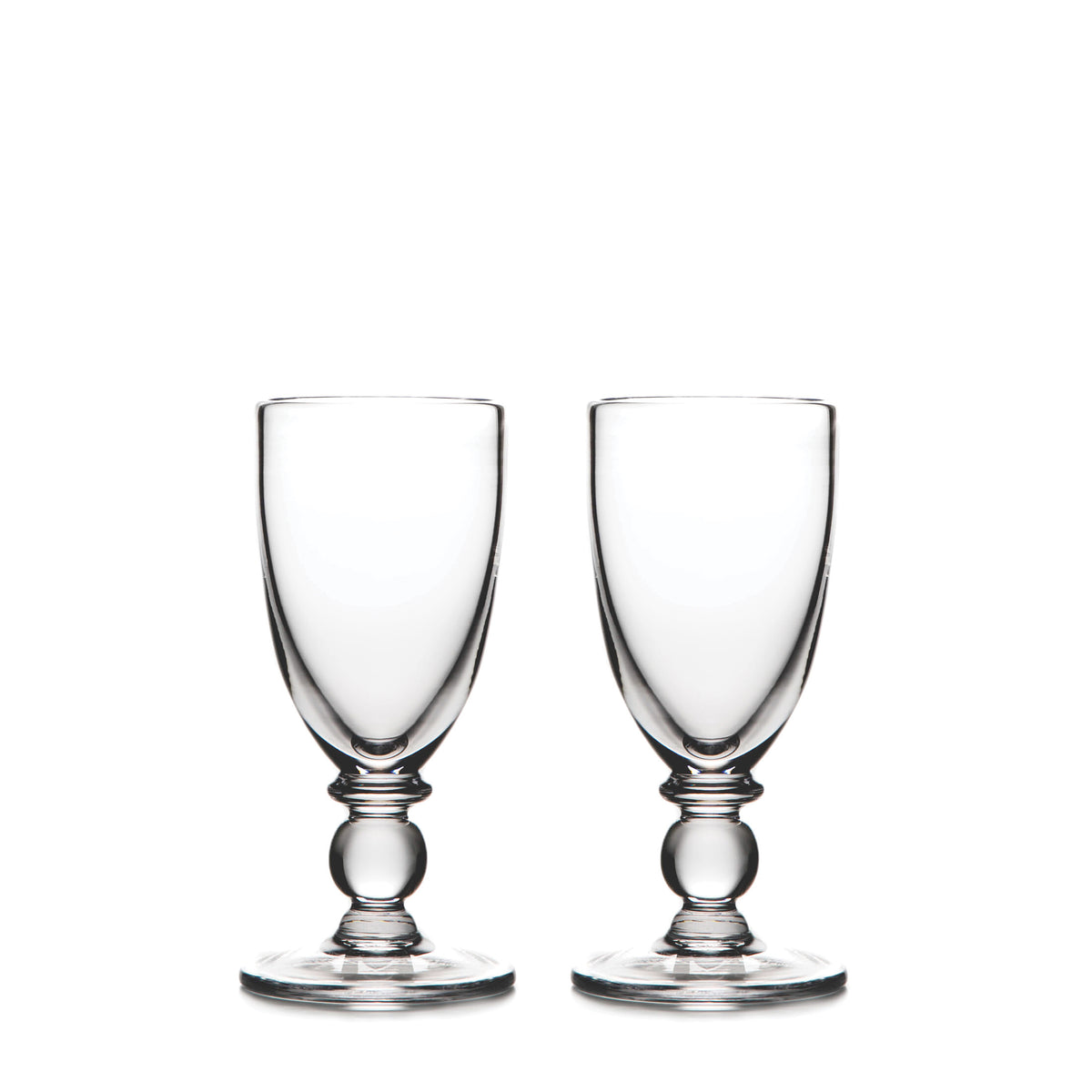 Two clear glass wine goblets with bulbous stems and round bases positioned side by side.