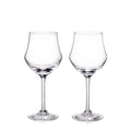 Two clear glass wine glasses with tulip-shaped bowls and long stems on white background.