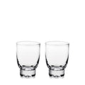 Two clear glass tumblers with thick bases displayed side by side.