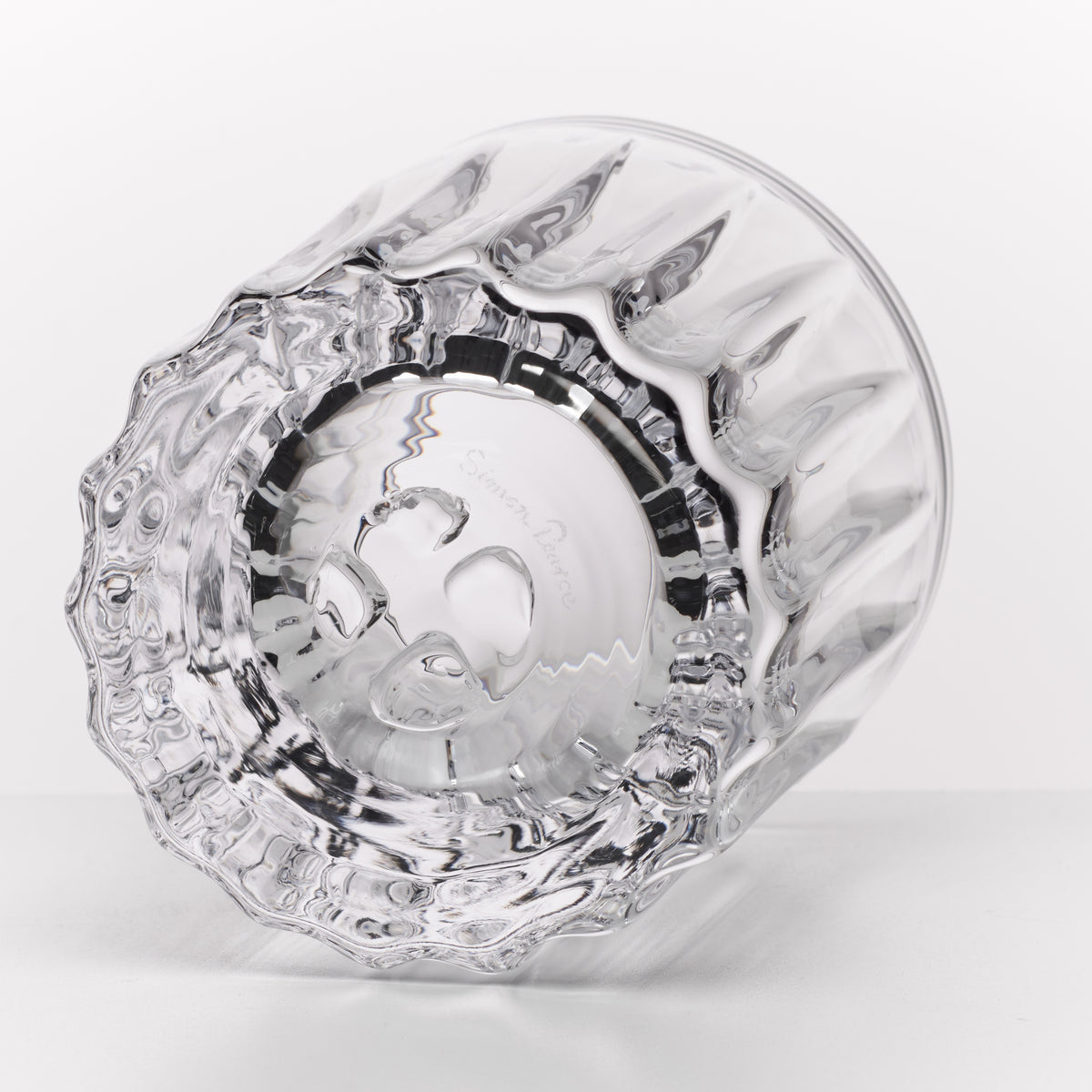 Two clear glass whiskey rocks glasses with textured base and black band detail, shown from overhead angle.