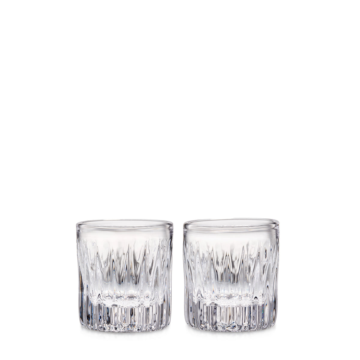 Two clear cut crystal whiskey glasses with geometric pattern design.