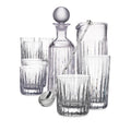 Crystal bar set with decanter, pitcher, four glasses, and bar spoon featuring vertical ribbed pattern.