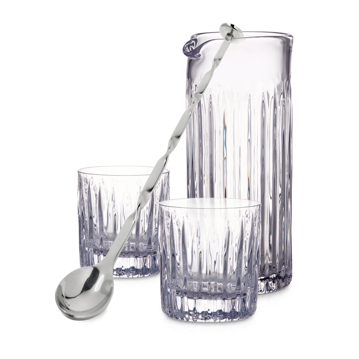 Crystal mixing pitcher with two matching glasses and long-handled stainless steel bar spoon with decorative handle.
