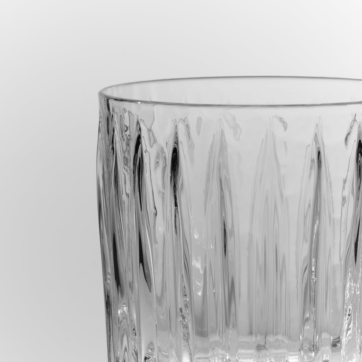 Clear glass double old-fashioned tumbler with vertical ridged pattern and smooth rim.