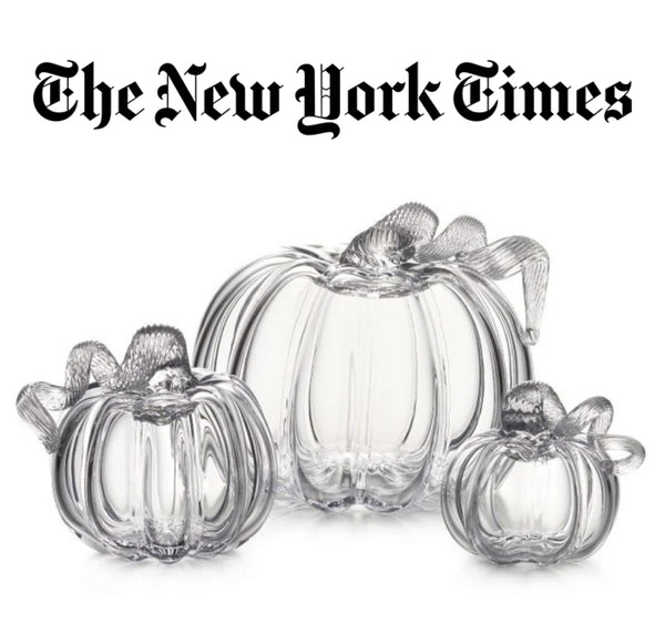 The New York Times feature: Three Simon Pearce handblown clear glass pumpkins in small, medium, and large sizes, with delicate textured stems, on a white background