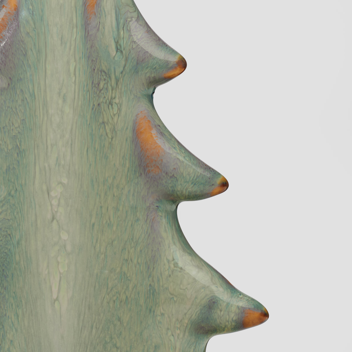 Ceramic vessel with moss green glaze and copper-brown accents, curved silhouette with protruding rounded nodules.