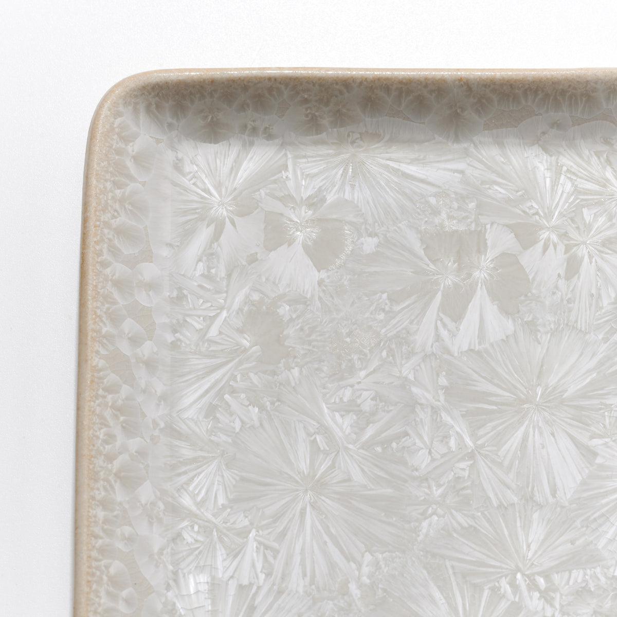 Clear crystalline rectangular platter with etched fan and geometric patterns throughout surface and decorative border.
