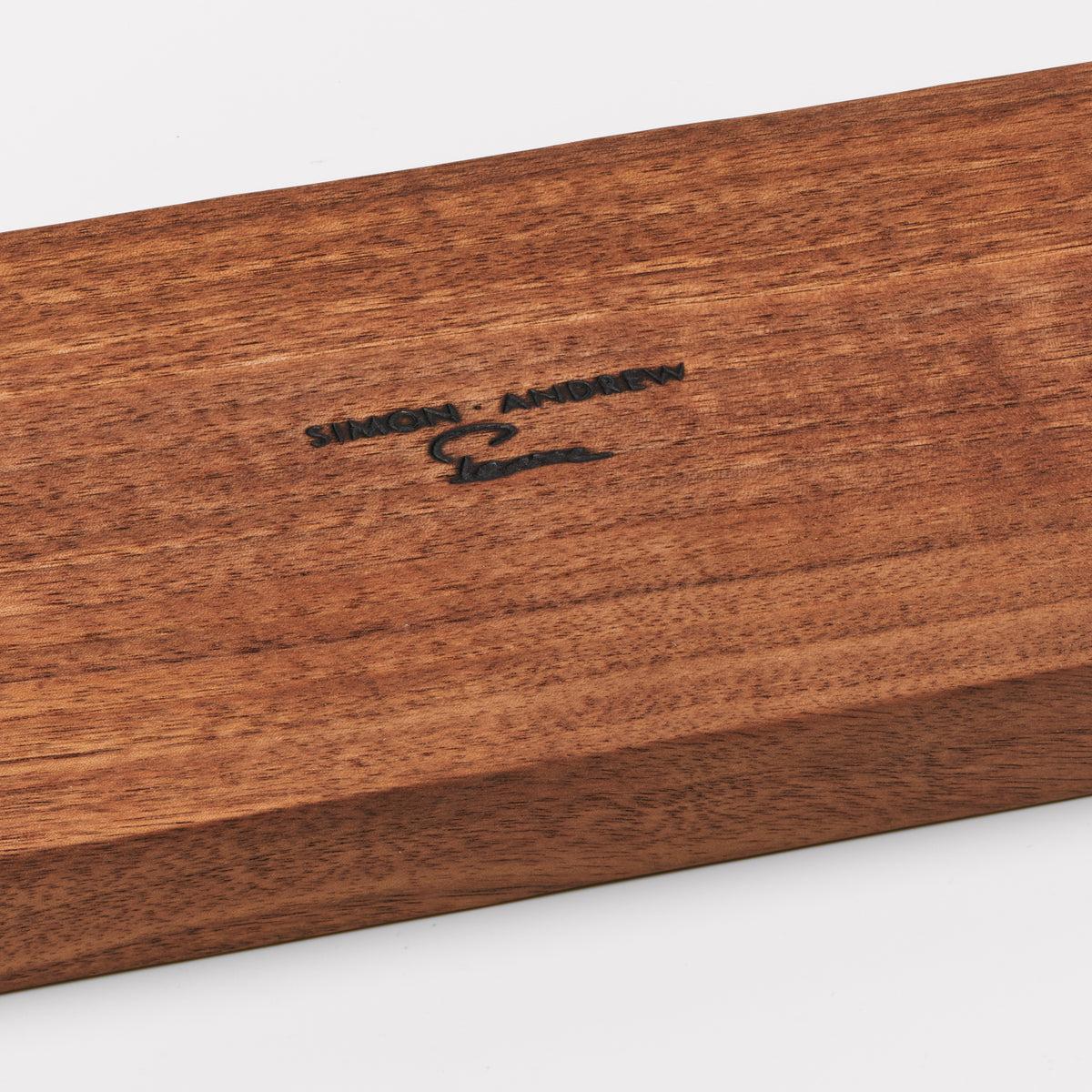 Wooden base with "Shoreham" branding engraved on surface.