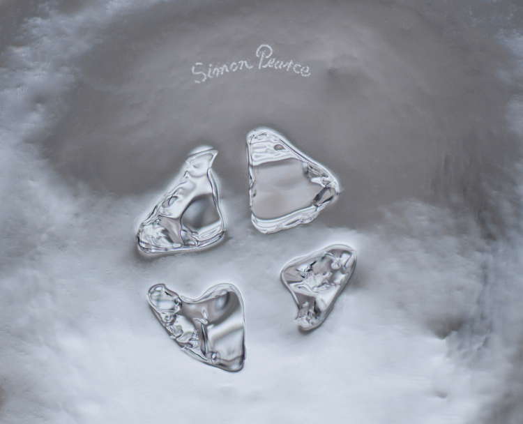Close-up of four irregular glass marks, showing the raw, organic impressions left by the glassmaking process when the pontil is released