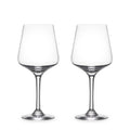 Two empty clear wine glasses with tapered bowls and thin stems on white background.