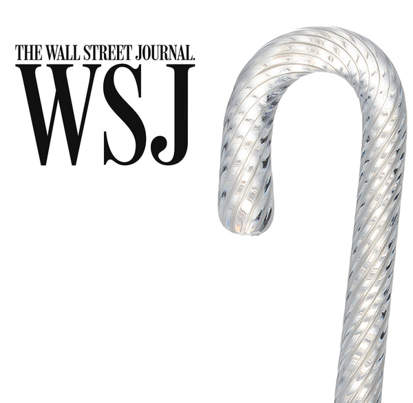 The Wall Street Journal feature: Simon Pearce handblown glass candy cane ornament with a twisted ribbed texture on a white background