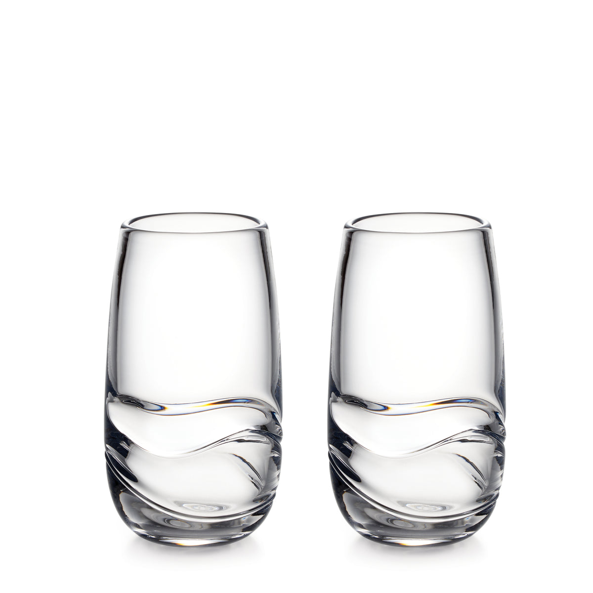 Two clear glass tumblers with curved linear design on lower portion.