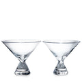 Two clear glass stemless martini glasses with wide bowls and weighted bases.
