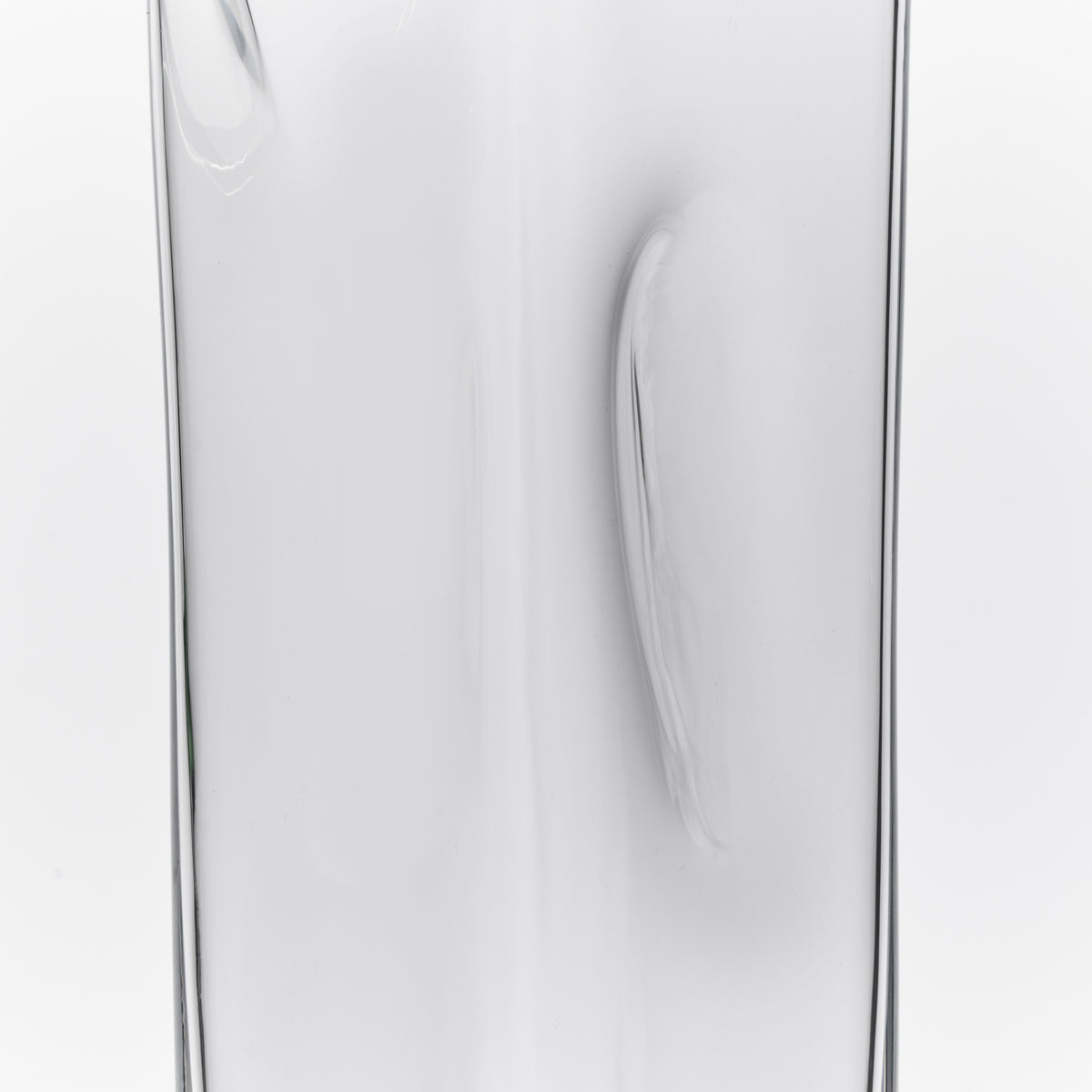Clear glass carafe with curved handle and tapered pouring spout.