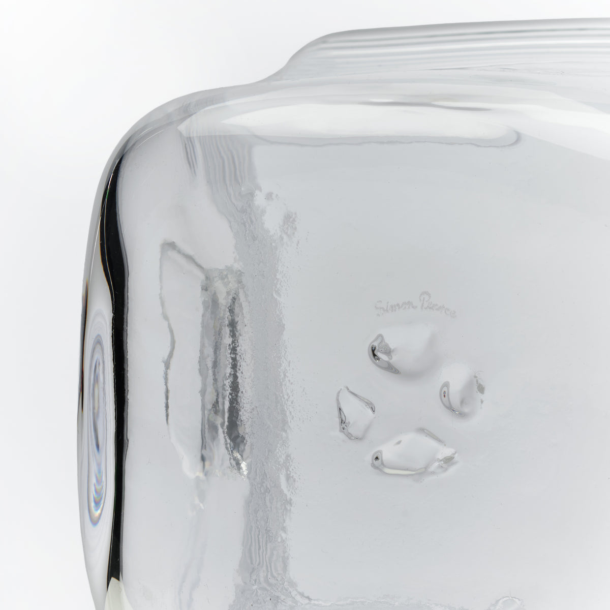 White ice bucket with condensation and frost on exterior surface, featuring curved handles and brand name etched on side.