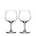 Two clear balloon-shaped wine glasses with stemmed bases.