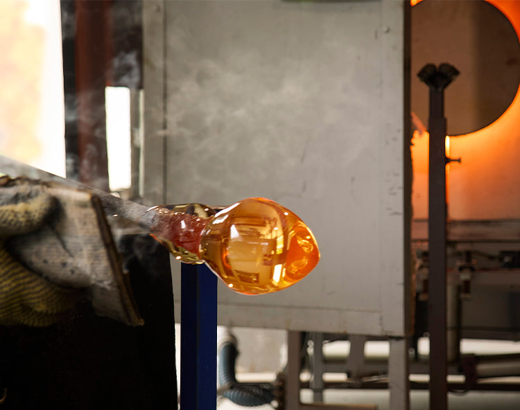 A Simon Pearce glassblower making a handblown glass item