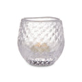 Clear glass tealight holder with textured bubble pattern containing a cream-colored tealight candle.
